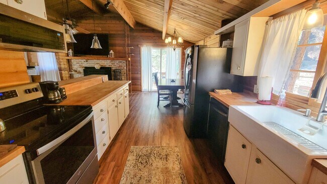 Building Photo - Move-In Ready 2-Bedroom Log Home with Wrap-Around Deck and Enclosed Yard