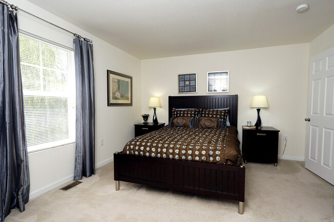 Bedroom with queen bed, dresser and night stands - Shadowmoss Pointe Apartments and Townhomes