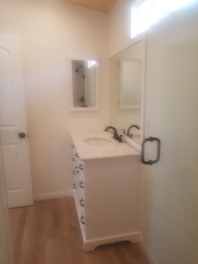 Master on suite bathroom with large stone top vanity and high ceilings - 6832 Zelzah Ave