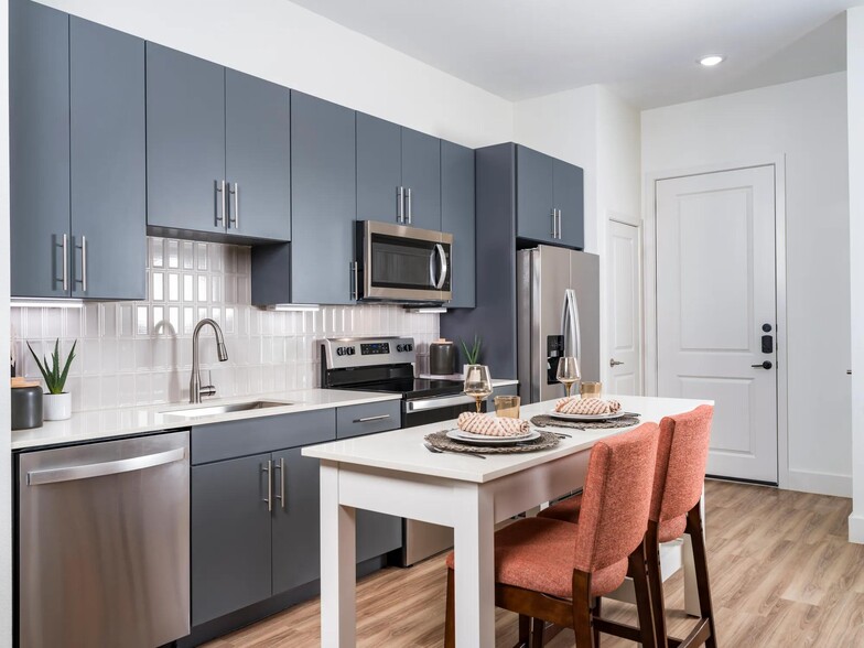 Discover ample space for meal prep and entertaining with the expansive chef’s kitchen island at Modera Garden Oaks. - Modera Garden Oaks