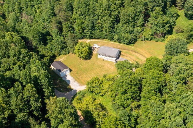 Building Photo - 3 br/ 2 bath home, private setting with garage/workshop