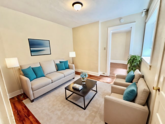 Step into relaxation with this beautifully designed living room, perfect for entertaining guests. - Cross Apartments