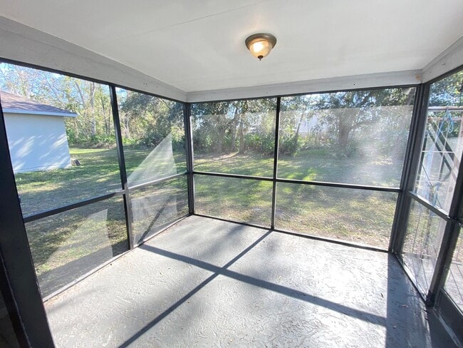 Building Photo - 2/2 home with garage - tile on inside with screened rear porch!