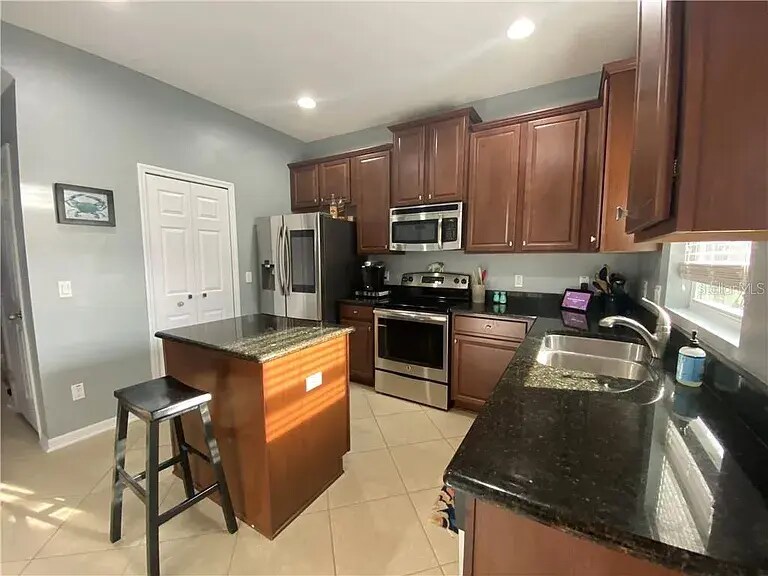 kitchen with small island and pantry - 504 Rainbow Springs Loop