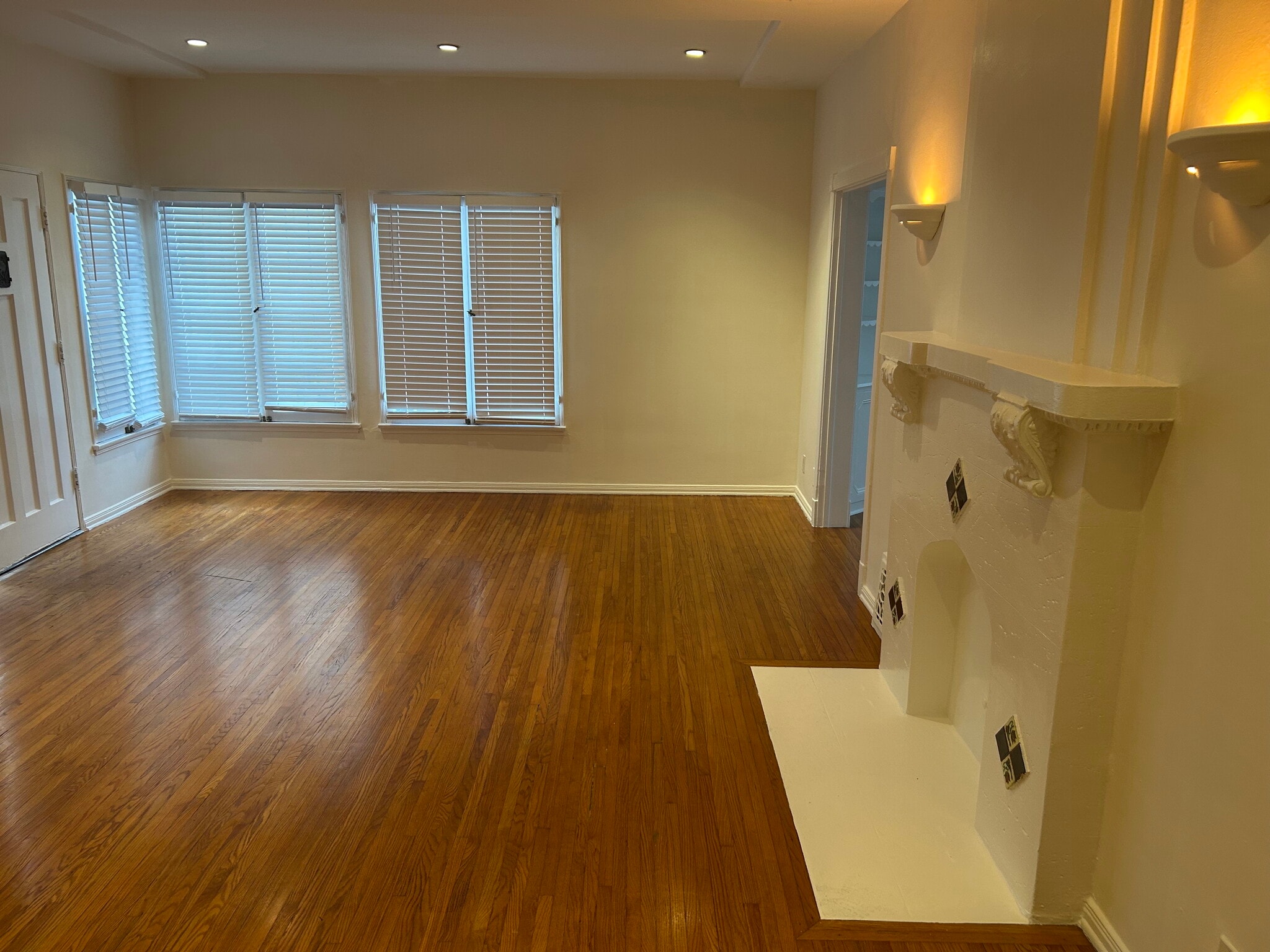 Living room with hardwood floors and recessed lighting - 6130 Orange St