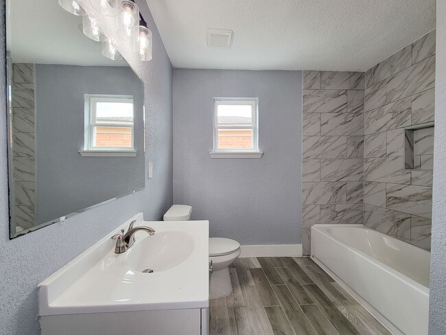 Building Photo - This beautifully updated 4-bedroom home is just under two miles from Highway 288 and Loop 610, ma...