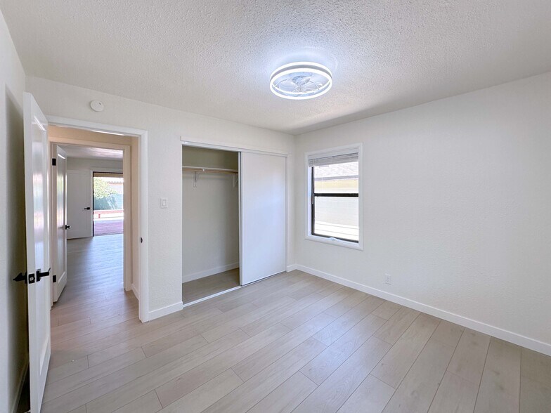 Light-filled Bedroom #1 with efficient AC, generous closet, and two windows for natural light. - 4570 58th St