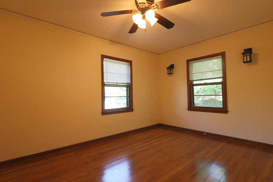 Large bedroom with sconces and ceiling fan - 2623 Terrace Rd
