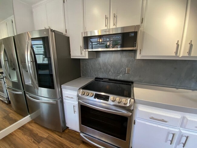 Building Photo - TWO PARKING SPACES INCLUDED! In Unit Washer & Dryer! Large Private Patio for Bikes, Boards and Bb...