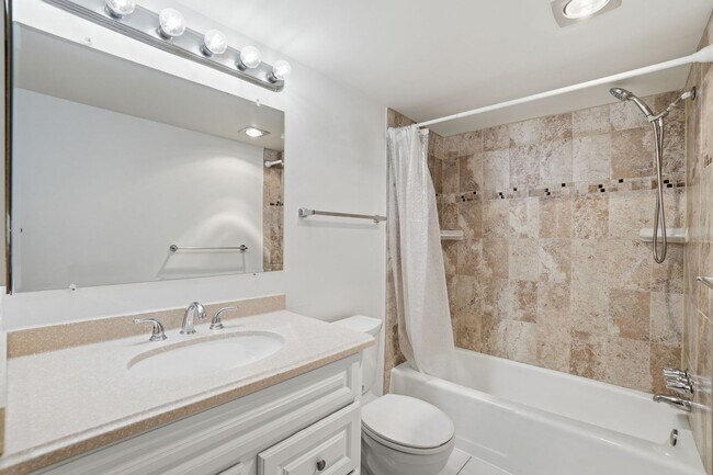 Building Photo - This expansive ground level residence is set within a serene, gated garden community surrounded b...