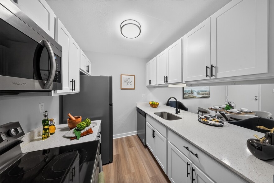 Elevate your living experience at The Woods at Ambler, an Eagle Rock Community. This modern kitchen features sleek appliances and stylish finishes, perfect for culinary adventures. Schedule a visit today to see it for yourself! - The Woods at Ambler, an Eagle Rock Community