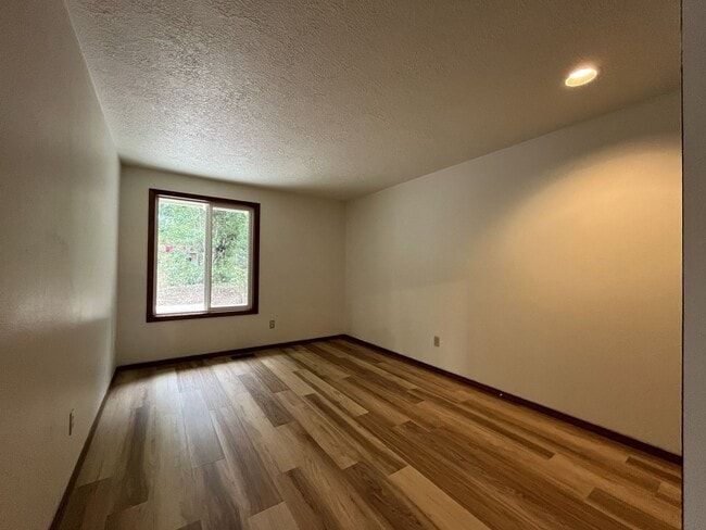 Building Photo - Spacious 3-Bedroom Home with Custom Stone Fireplace, Attached 2-Car Garage & Expansive Backyard i...