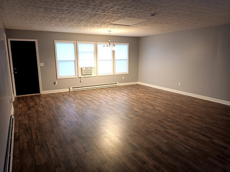 The back of the living room can be a dining area in front of the windows. - 303 Fleetwood Dr