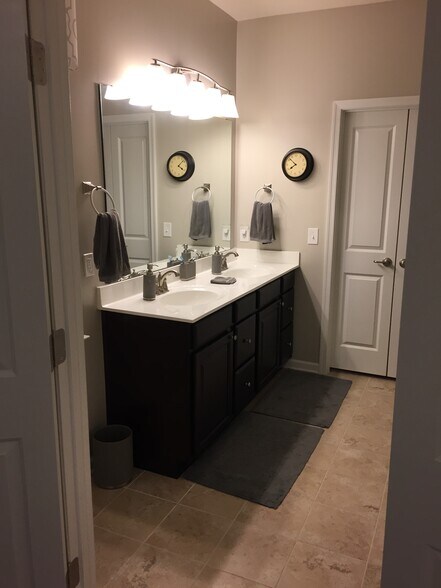 Master bath ensuite (double doors open into the custom cabinetry closet) - 7736 Tranquil Trl