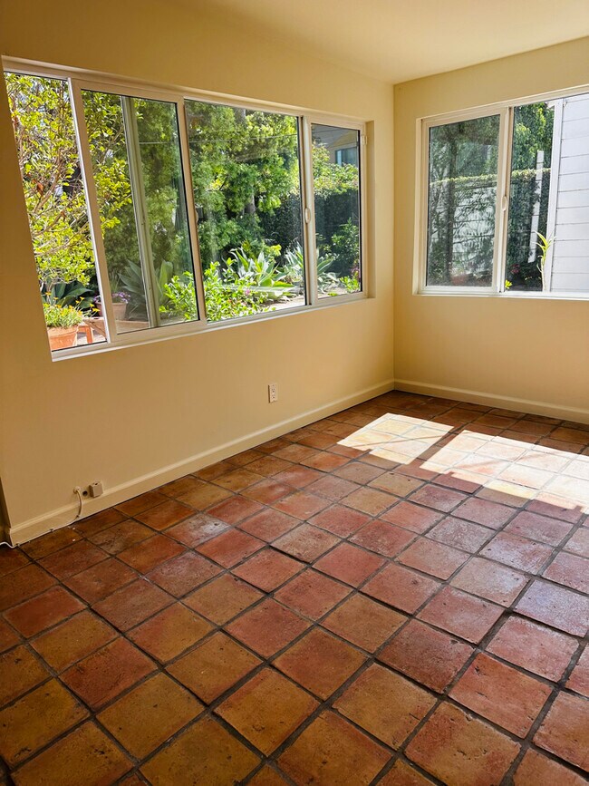 Bright sunroom off bedroom with Saltillo tiles, windows & sliding door, adding more living space! - 924 Nowita Pl