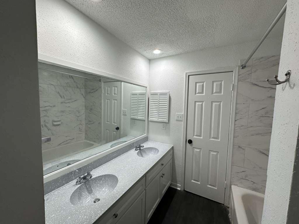 Primary Bathroom: Double vanity, soaking tub, and linen closet - 7700 Creekbend Dr