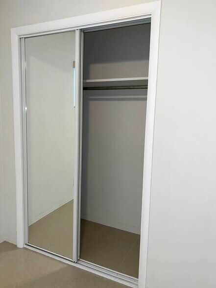 Bedroom closet with mirrored doors - 5010 SW 26th Ave