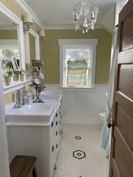 The bathroom is equipped with dual sinks, offering ample space and convenience perfect for guests sh - 3012 N 22nd St