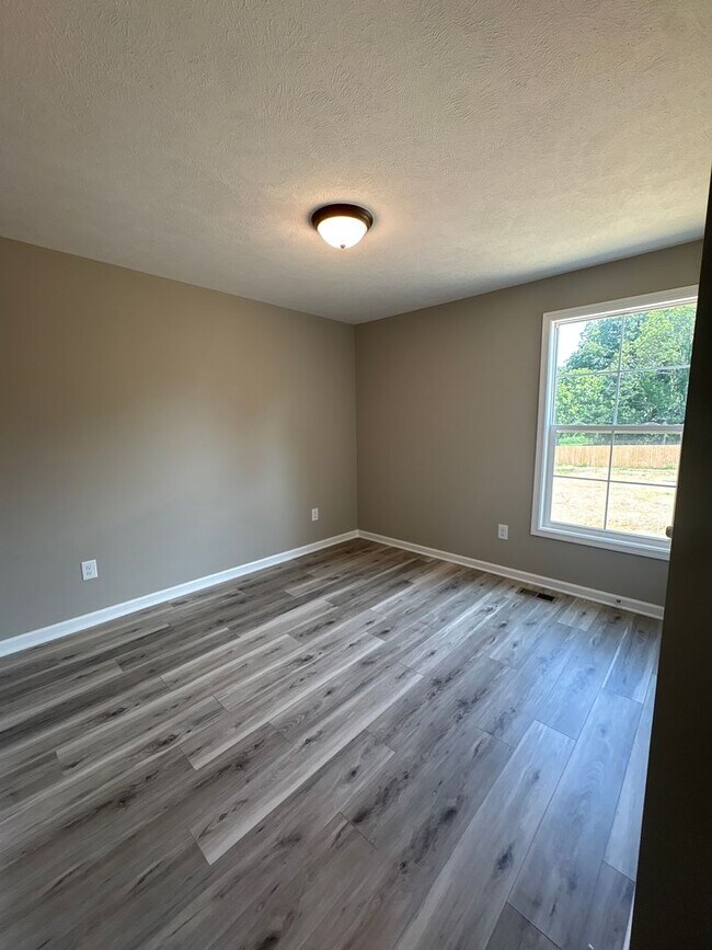 Building Photo - Charming New Home with a Rocking Chair Front Porch!