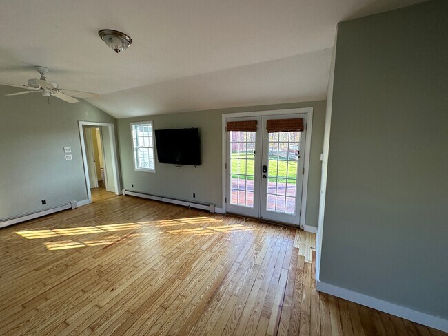 Downstairs living room and French doors to rear deck - 480 Newington Rd