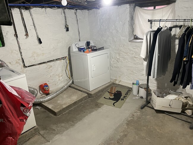 Washer and dryer hookups in the shared basement laundry - 5033 Devonshire Ave