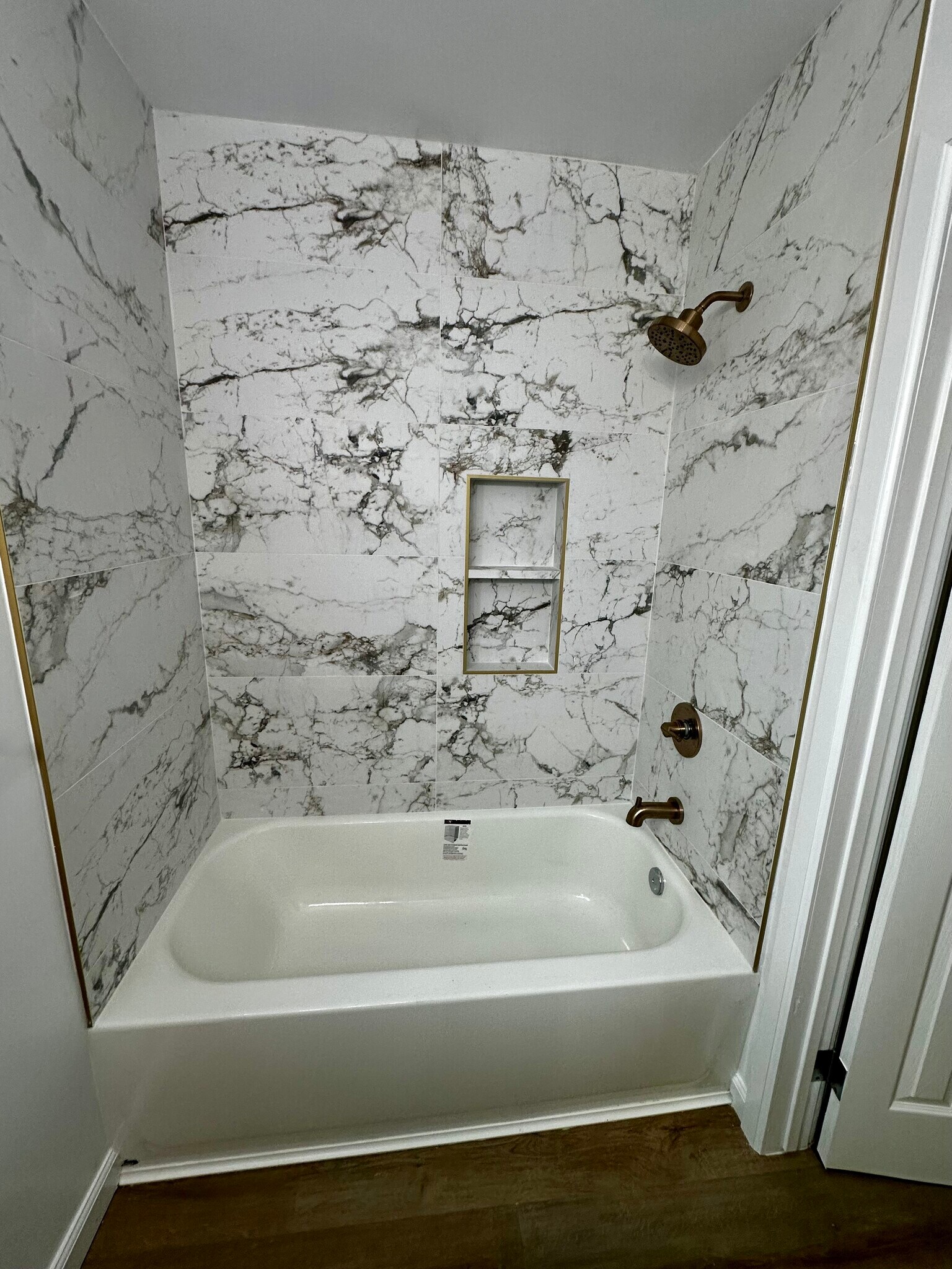 New bathtub and porcelain tile with cold accents. - 2132 W 104th St
