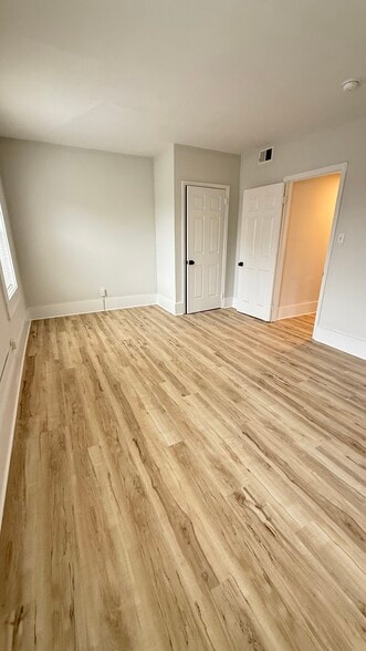 Primary bedroom with large closet and new flooring - 1024 W 8th St