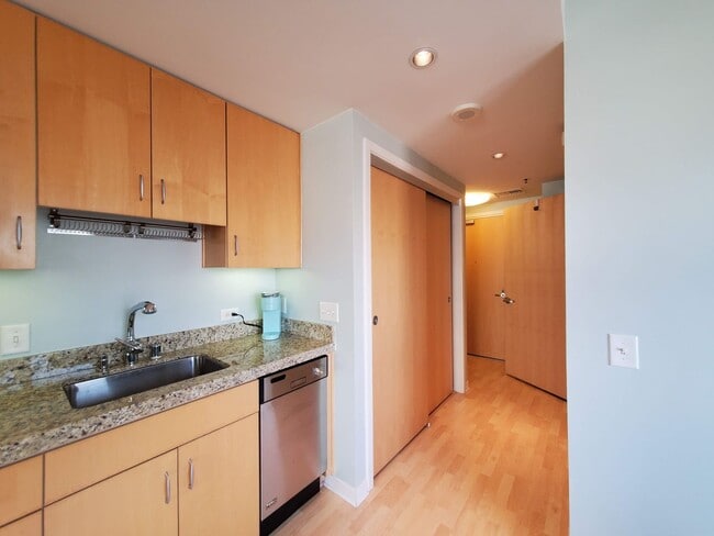 Building Photo - Downtown High-Rise Studio with parking and in-home laundry