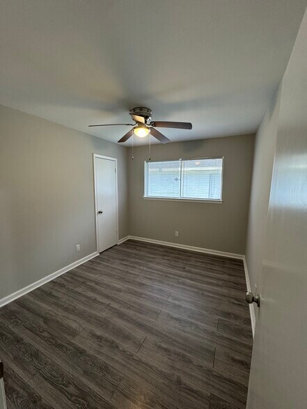 Another versatile bedroom with ceiling fan and new wood-look flooring. - 11927 Troulon Dr