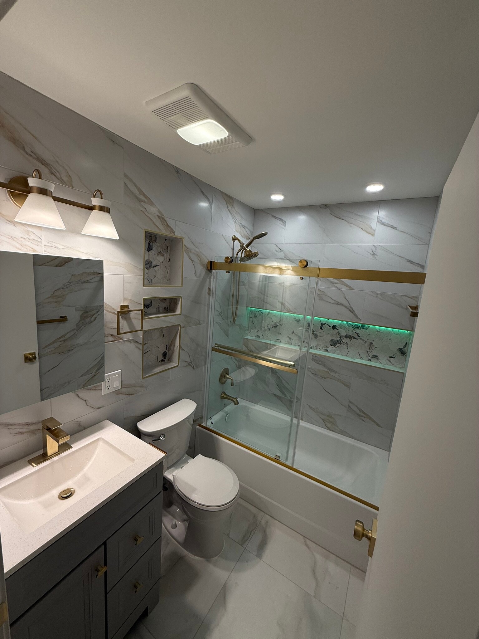 Bathroom w/shower door & gold trim accents - 46 Hull St