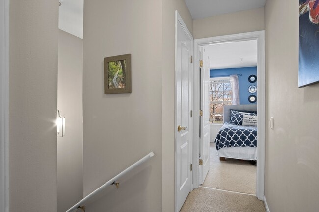Building Photo - This inviting two-level townhome offers comfort and style, featuring gleaming hardwood floors on ...