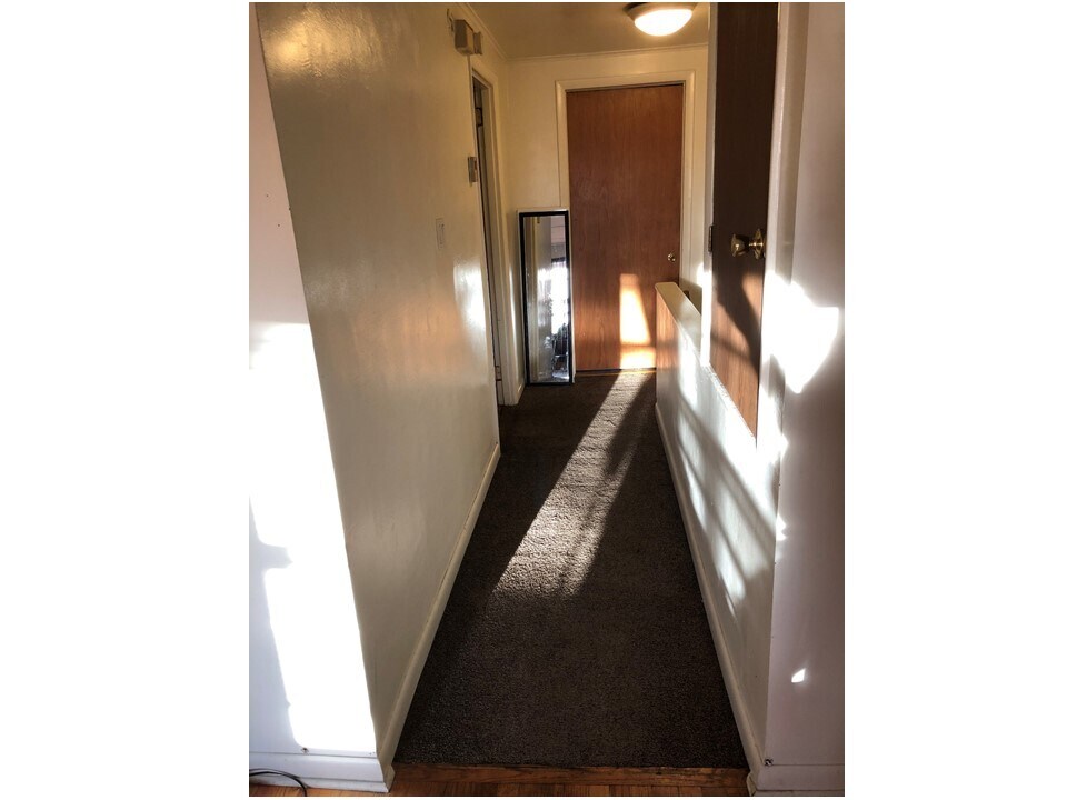hallway, bedroom on left, bath at end, stairs to right, storage on right - 419 N 2nd St