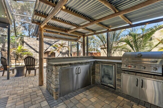 Building Photo - A vibrant 2-bedroom, 2-bathroom tropical retreat designed for both high-energy entertaining and l...
