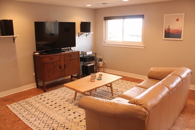 Living room with large TV - 13652 W Montana Ave