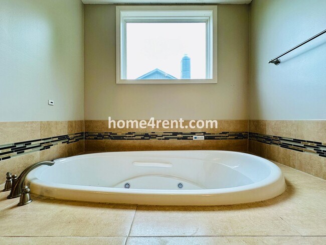 Building Photo - Beautiful Four-Bedroom Home with Three Car Garage, Wood Floors, Finished Basement and a Fenced Ya...