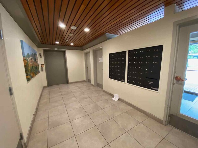 Entry area with elevator, mailboxes, and secured package room - 3183 Wayside Plz