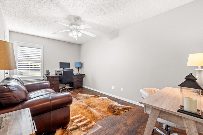 Large bedroom, currently set up as an office, with oversized walk in closet. - 209 Prairie Wind Blvd