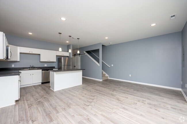 3BR, 2.5BA - 1,500SF - Living Room/Kitchen - Homestead Townhomes