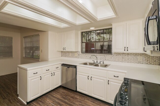 Building Photo - Charming 2-Bedroom Condo in Gated Community Surrounded by Mature Trees