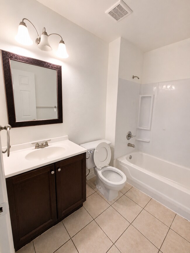 Building Photo - Convenient location, new paint & carpet throughout, enclosed patio.