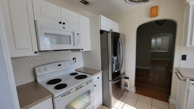 Kitchen from bonus room entrance. New cabinets and microwave. - 4359 4th Ave. S.