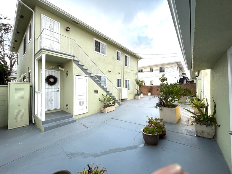 Rear entry door and court yard with garages - 5727 S Corning Ave