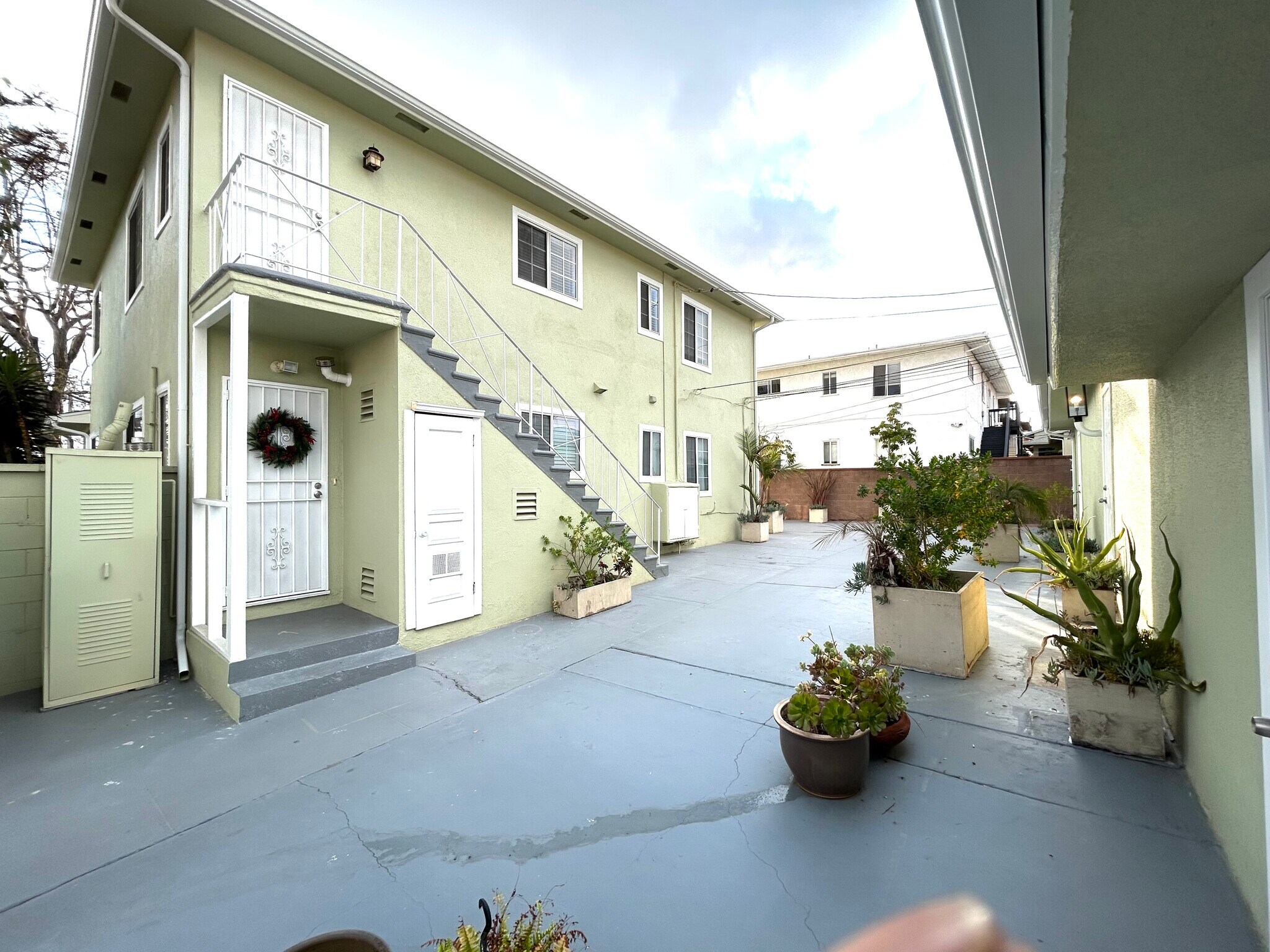 Rear entry door and court yard with garages - 5727 S Corning Ave