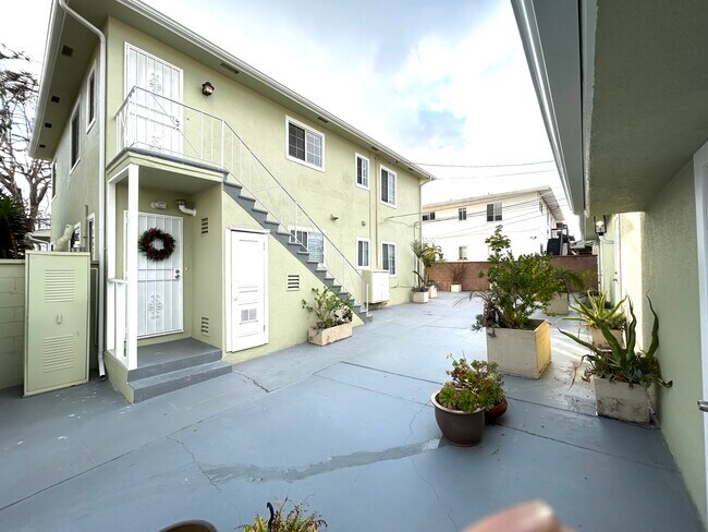 Rear entry door and court yard with garages - 5727 S Corning Ave