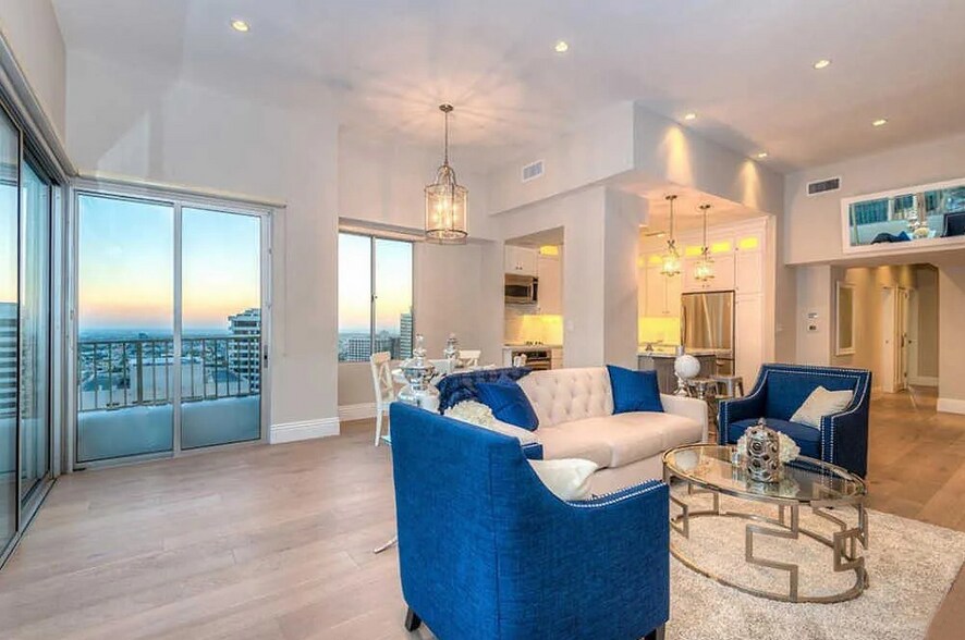 Living room w/ view into kitchen - 10501 Wilshire Blvd