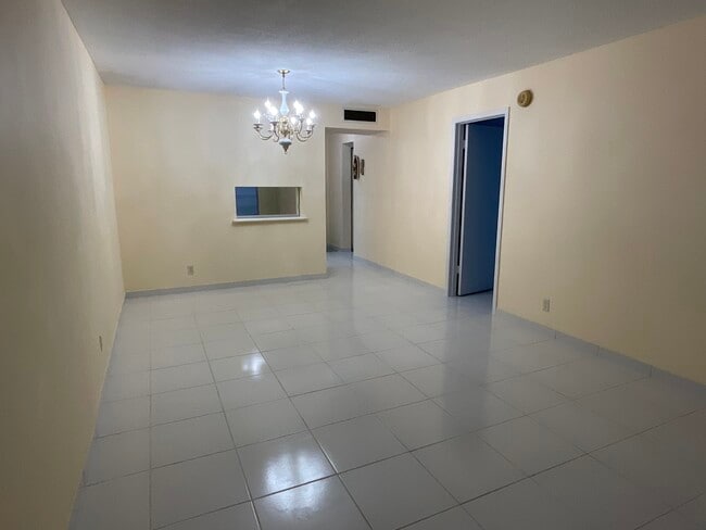 Looking from living room area toward dining room with a pass through to kitchen - 2900 NW 47th Terrace
