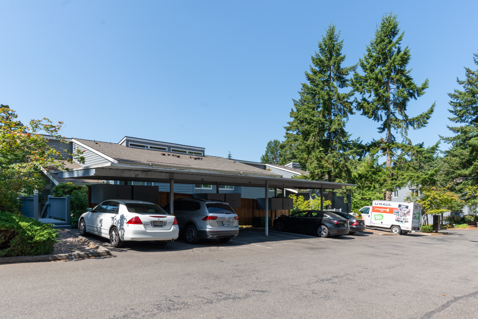 View of the one dedicated covered carport parking space (#29) with built in storage cabinet - 9350 Redmond Woodinville Rd NE