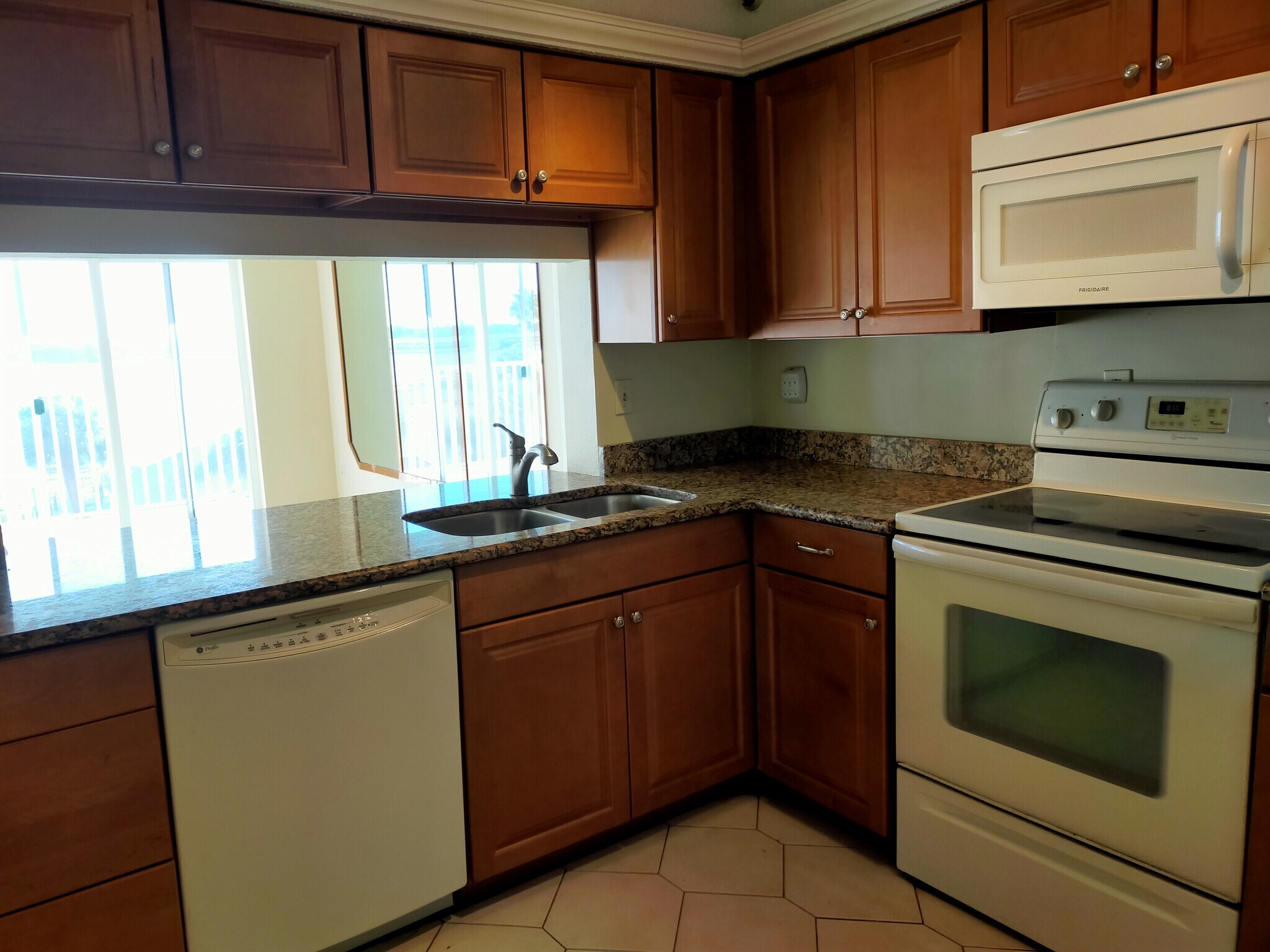 Kitchen open to LR with water view - 7432 Sunshine Skyway Ln S