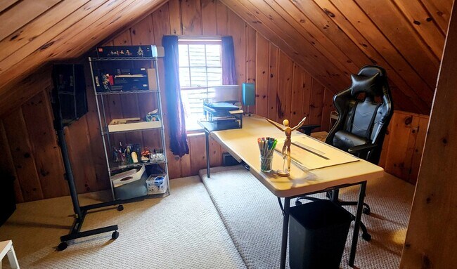 Versatile loft space currently set up as a home office, with natural light and ample room for a desk - 2923 Arthur St NE