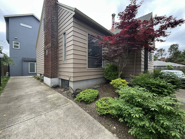 Building Photo - Three-Bedroom Home with Updated Kitchen & Vaulted Ceilings, large open basement, Hardwood floors